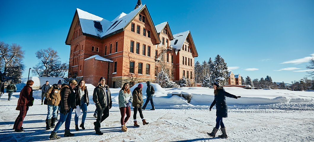 Campus tour in front of Montana Hall in winter.