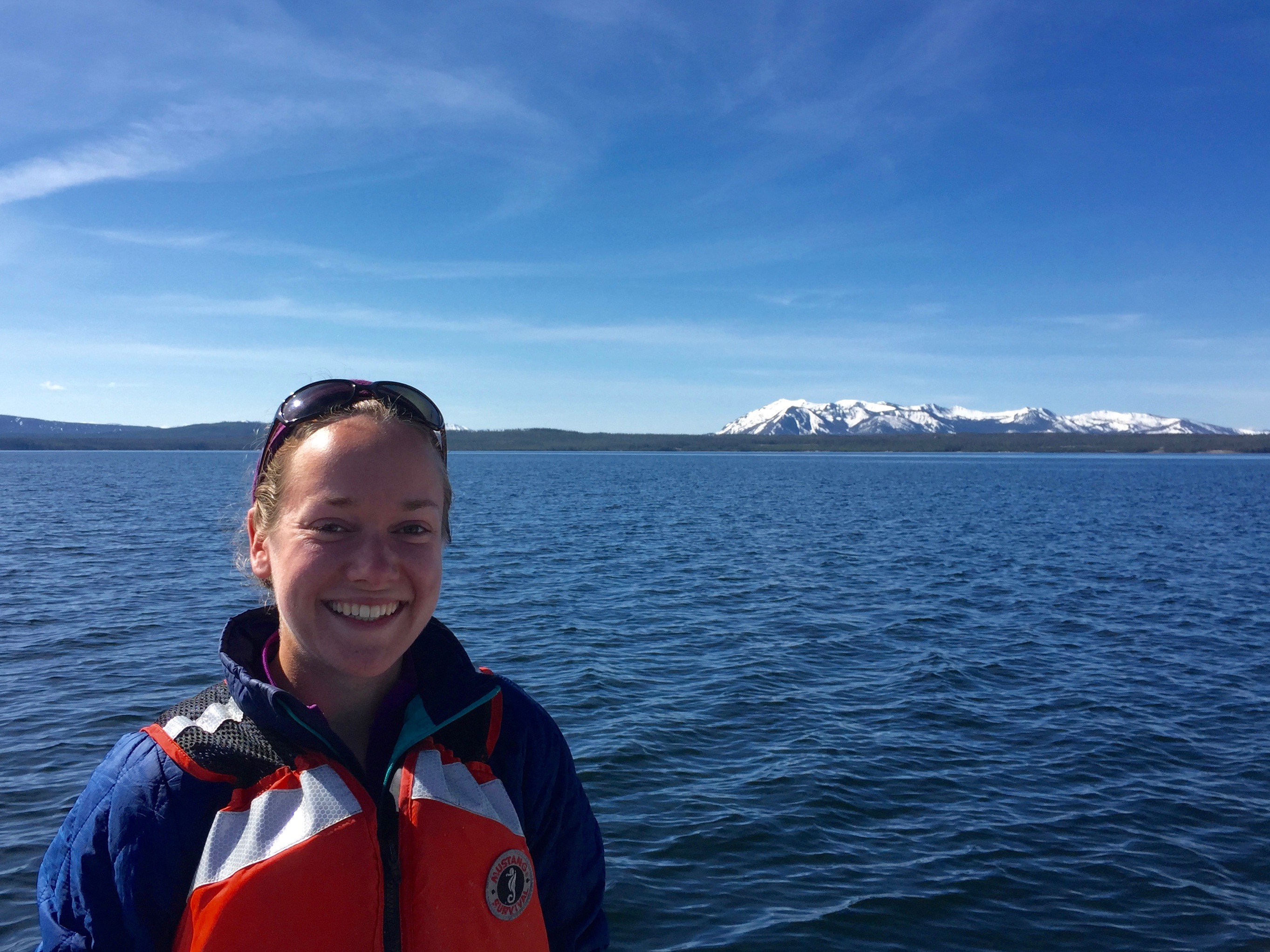 Michelle in front of body of water and distant snowy mountains