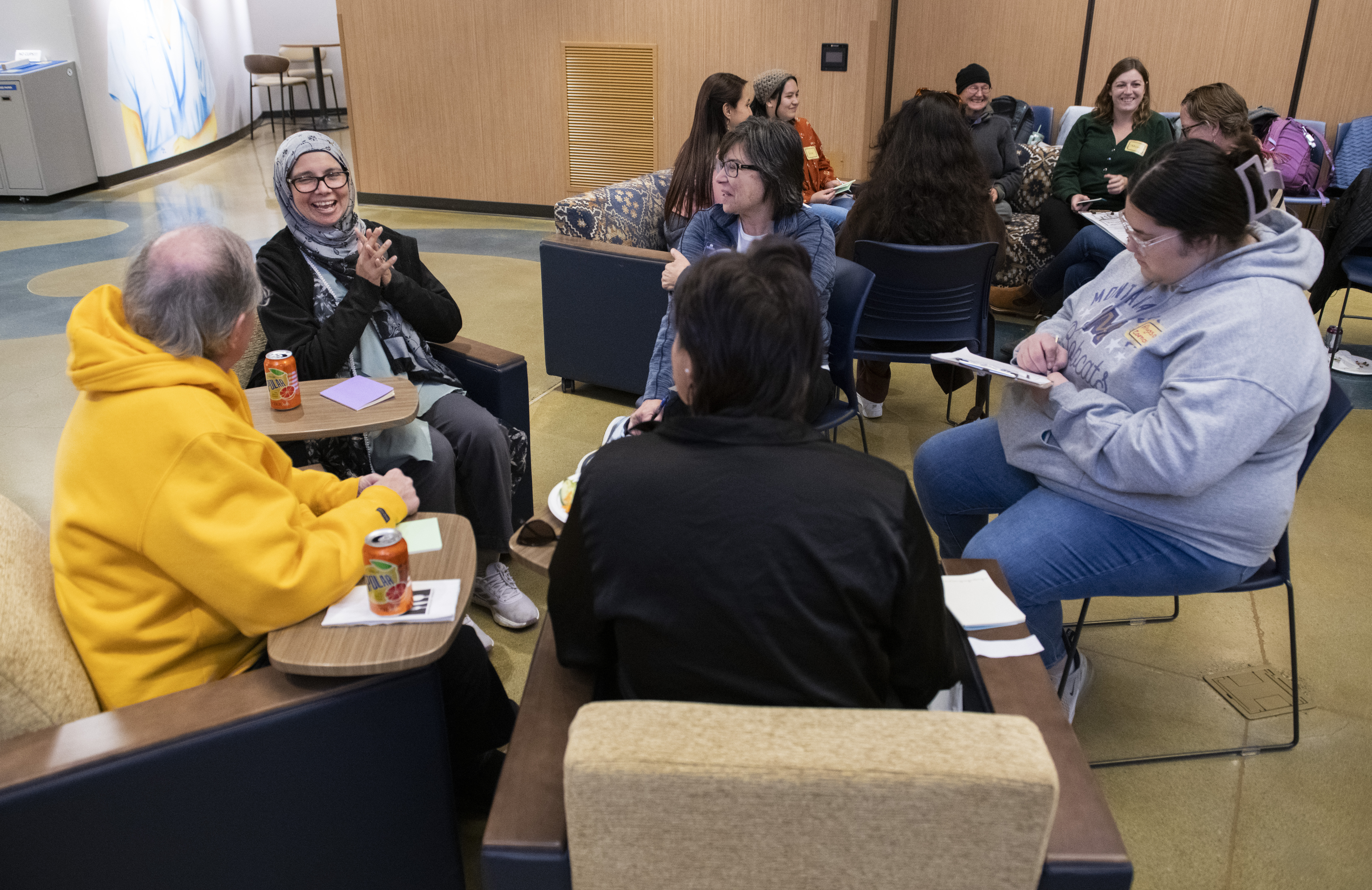 Small group engaged in conversation for Fall 2023 Language and Story Exchange