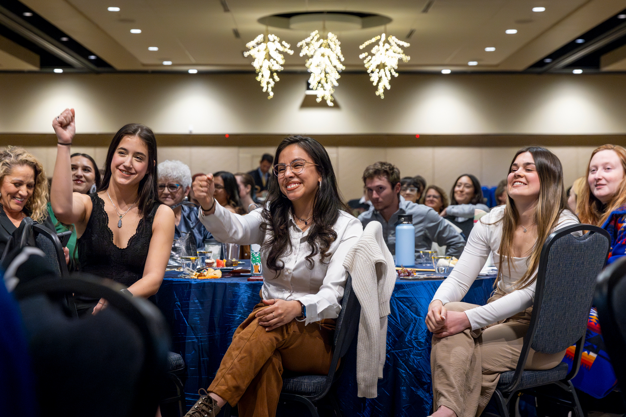 Students sitting at table during awards ceremony