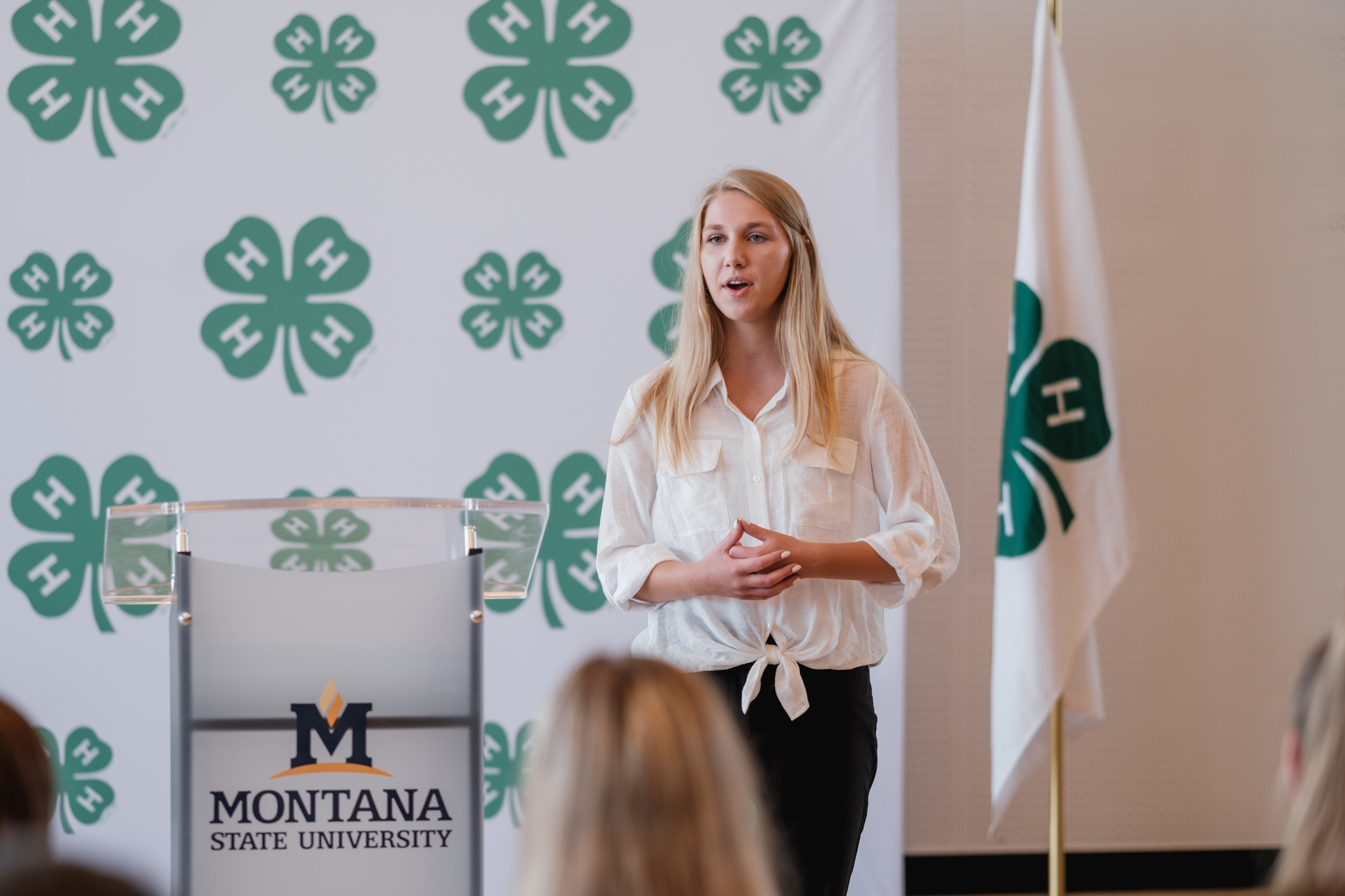 A female club member practices public speaking