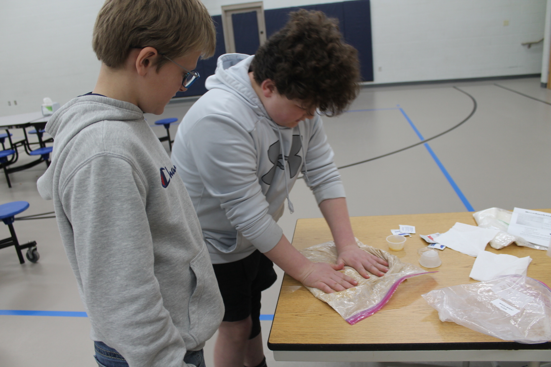 Students kneading bread dough