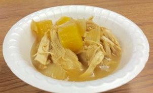 An image of slowcooker pineapple chicken in a white bowl.