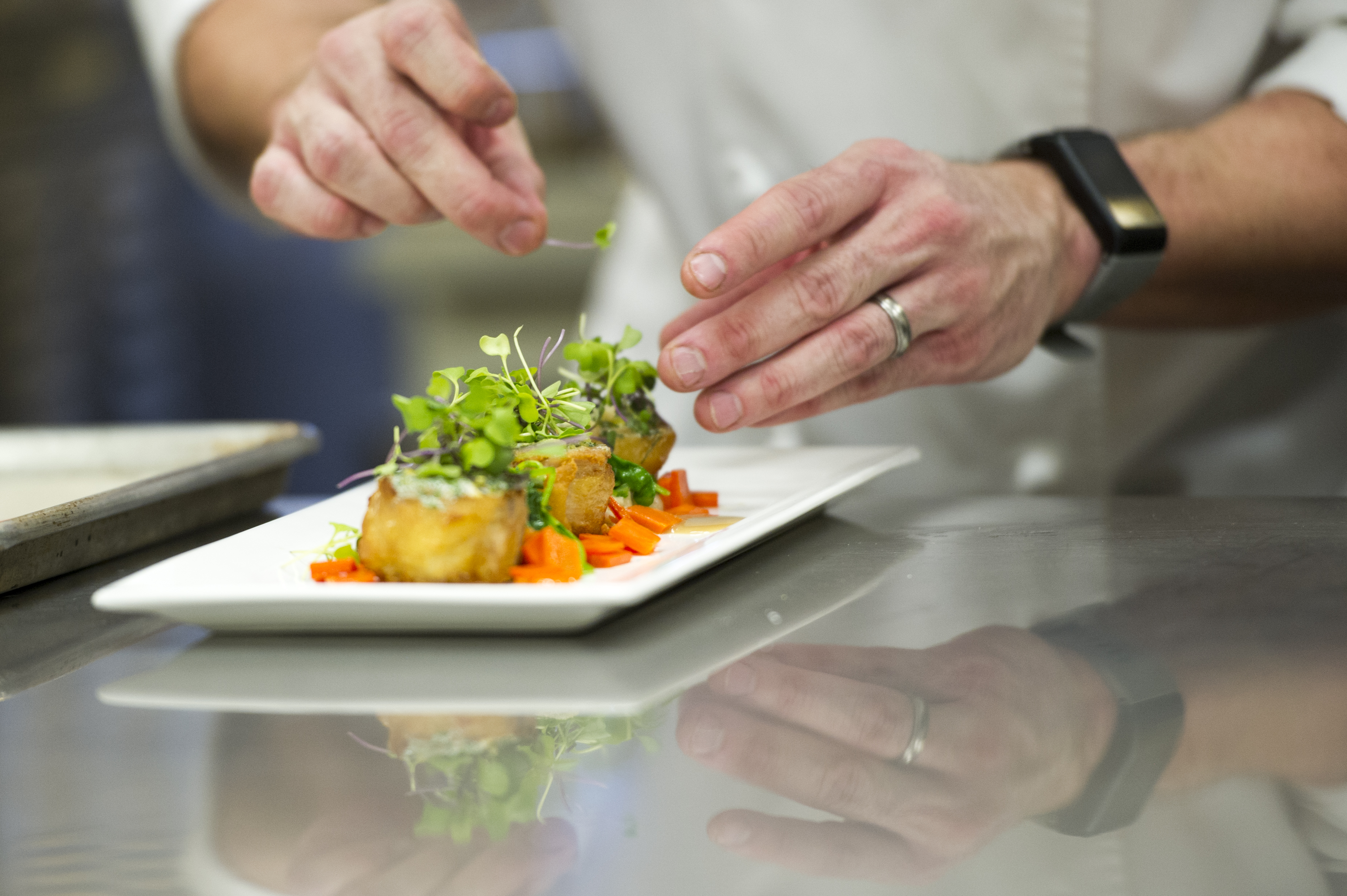 MSU instructor plates a fish dish.