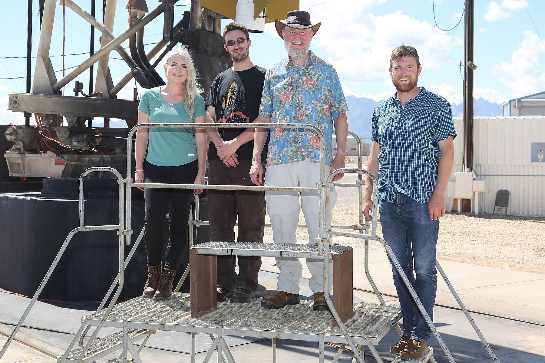 four ppl on scaffolding