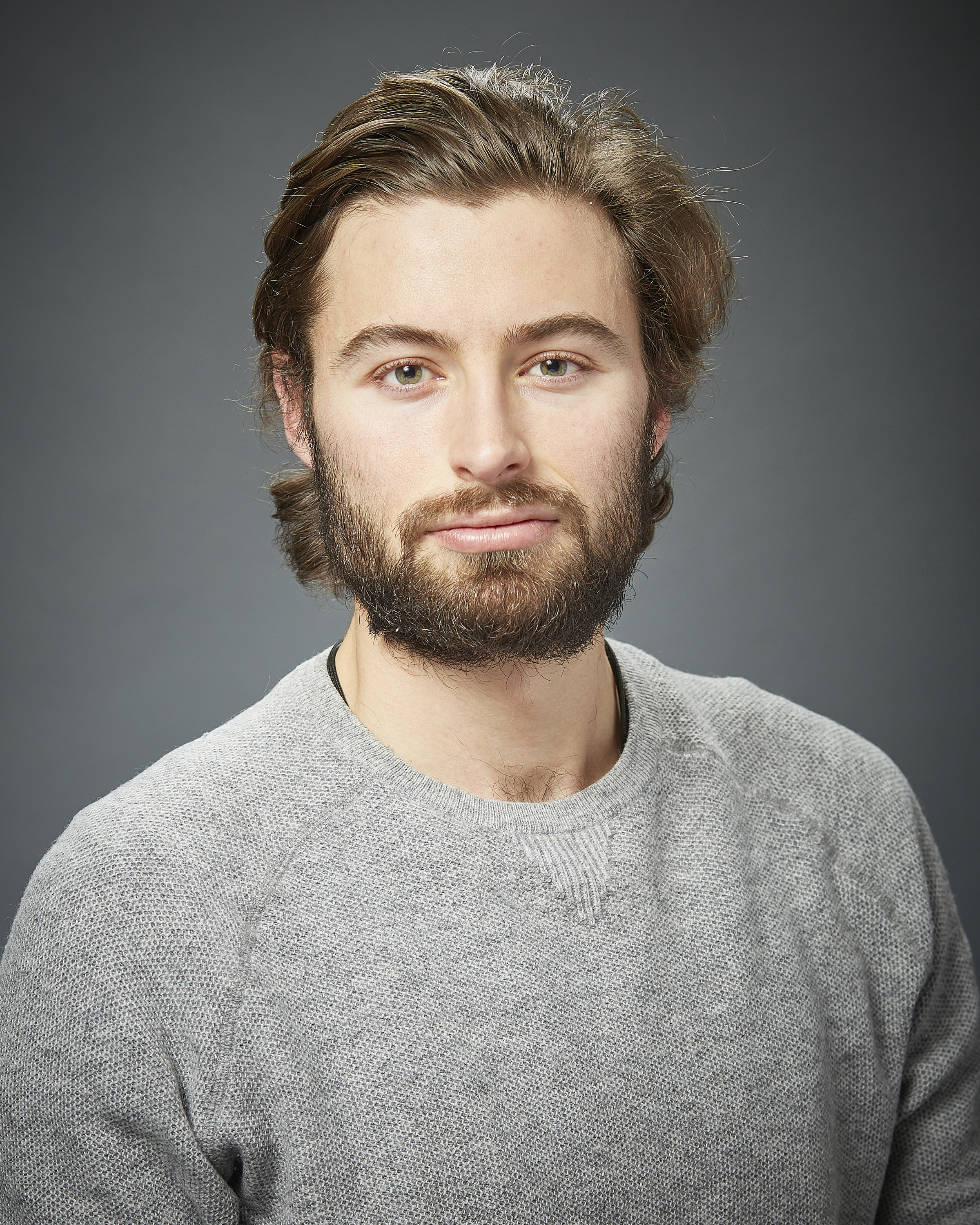 Will gazes deeply towards the camera, his full beard and pulled back hair allude to a relaxed determination